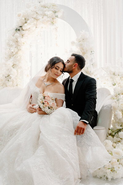 couple kissing on wedding day