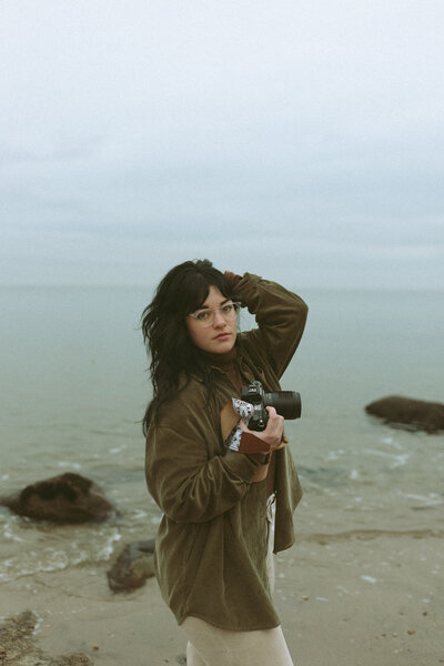 Photographer with camera in hand on the beach
