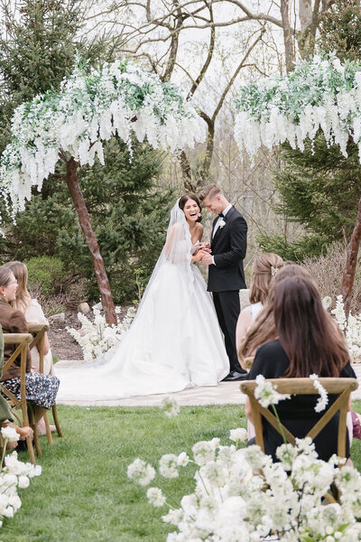joyful bride and groom at outdoor Michigan wedding ceremony