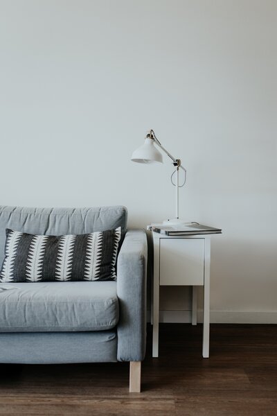 Grey sofa with end table and lamp