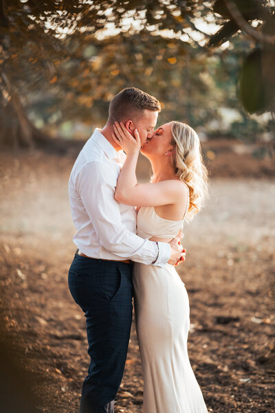 Romantic photo of bride and groom sharing a kiss by the Sydney waterfront