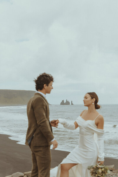 Couple sharing a romantic moment during their Iceland beach elopement, captured by Bare Bones Photo