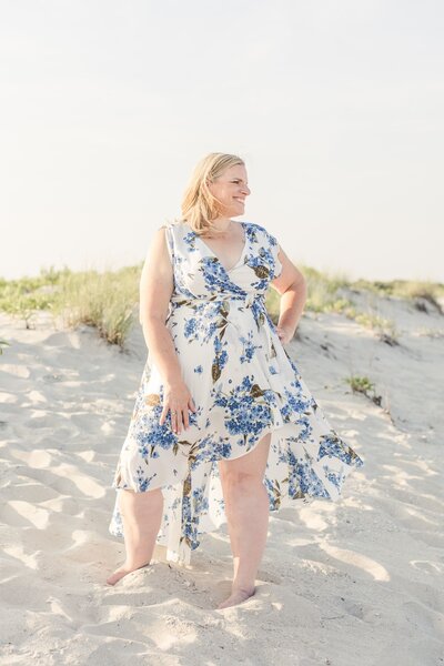 Woman on beach in floral dress