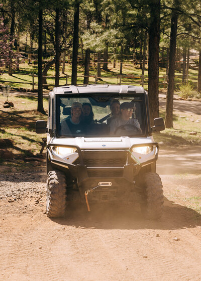 A group of women sit around a dining table smiling. 
