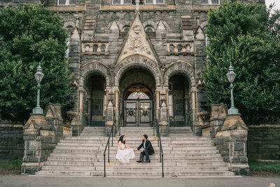 timeless wedding photo of bride and groom stand by each other on a hotel deck WITH Washington D.C. monument in the back