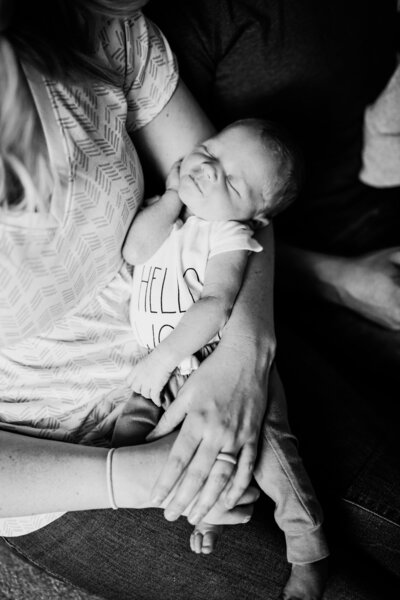 A smiley baby being held in his mother's arms in Noble, OK.