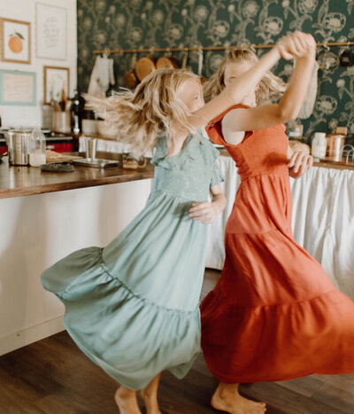 Two girls dancing in a kitchen