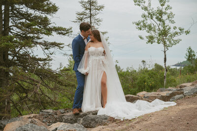 couple cuddling together on top of cliff