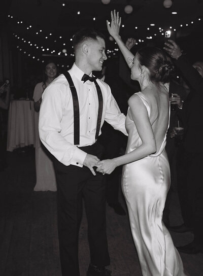 Couple in wedding attire dancing together on the dance floor