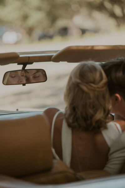 couple in a vintage car on their wedding day in San Diego county
