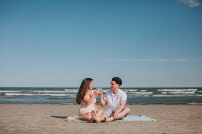 Couple having a glass of champagne and cheering at New Jersey Wildwood Beach