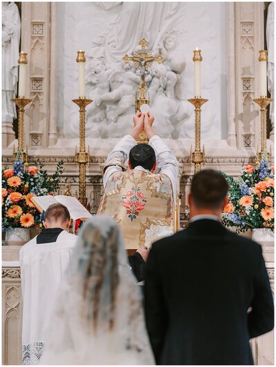 Eucharist blessing during traditional Latin Mass wedding at Our Lady of the Assumption Church in Walton, KY