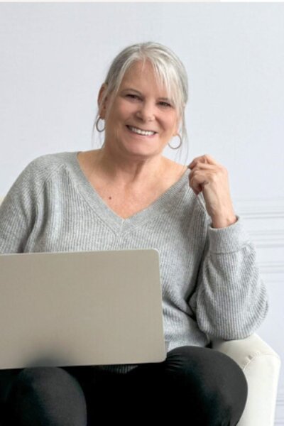 Image of a  professional looking woman smiling and talking on the phone