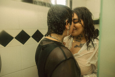 A couple kissing in a shower.