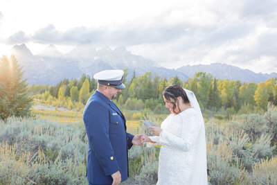 Idaho Falls photographers capture bride and groom reading vows during Idaho wedding