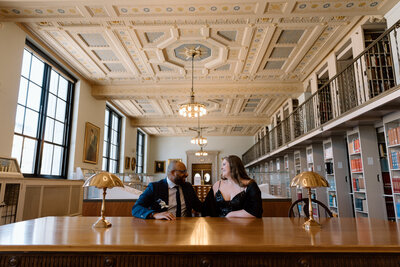 Bride holding up a bouquet of flowers during a beach elopement in Michigan.