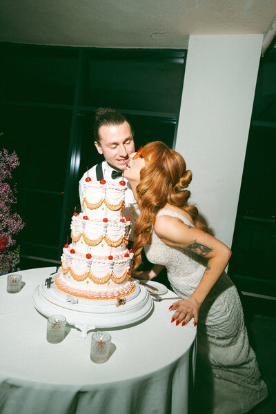 Candid moment of bride and groom with wedding cake – authentic wedding photographer Charleston SC film photographer
