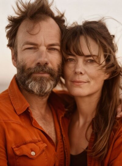 Close-up of a couple embracing with calm, confident expressions, symbolizing trust, healing, and renewed connection through the Infidelity Recovery Coaching Program It's Okay to Stay by Relationship Experts and Idit Sharoni, LMFT.