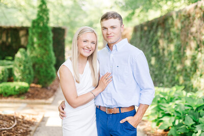 Engaged couple smiling at camera at Jule Collins Smith Museum in Auburn AL | Wedding Photographer Amanda Horne