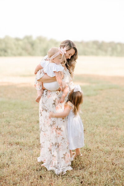 Family smiling during a Raleigh NC maternity session. Photographed by Raleigh maternity photographers A.J. Dunlap Photography.
