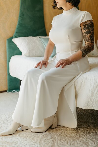 Bride Siting on Bed in Custom Pantsuit - Megan & Amber | Hood River Wedding  - LGBTQ Wedding