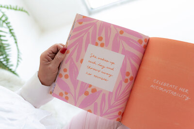 Pink book on mid-life crisis coaching, adorned with a floral print and featuring an inspirational quote. This book offers guidance and support for women navigating life transitions and personal growth.