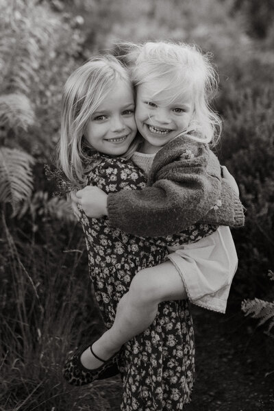 black and white family outside sunset kids in blanket in field
