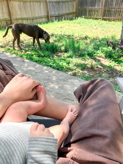Sitting in the backyard with a baby in my lap.