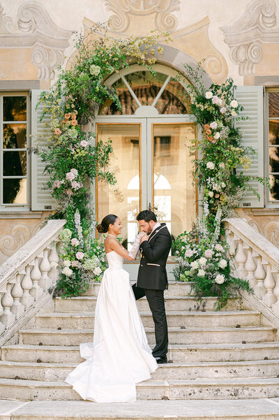 Bride and Groom holding hands during wedding ceremony in Italy. Photographed by luxury wedding photographer, Sarah Woods.