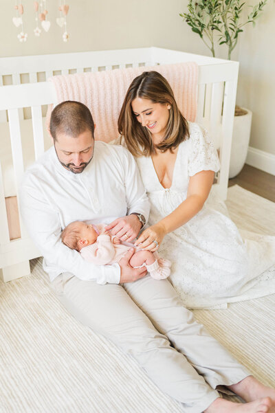 Douglas Massachusetts newborn photographer shot of a woman and a man looking lovingly at their newborn baby