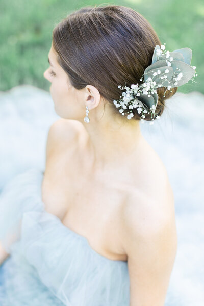 close up of a bride with a floral hairpiece