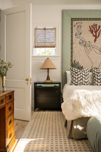 Reading nook with white chair, fiddle fig leaf tree and colourful wallpaper