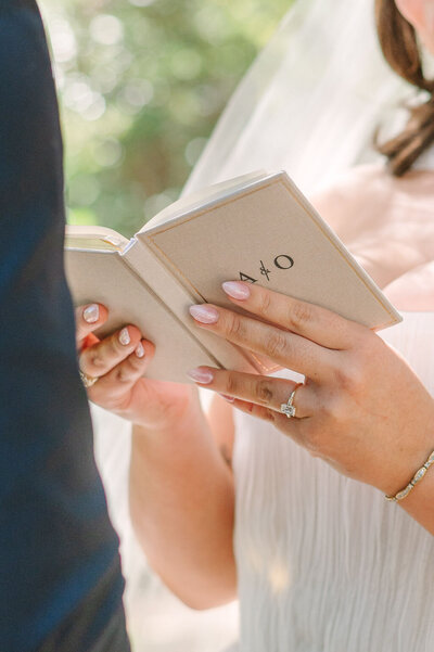 Bride holding vow book at Texas Hill Country colorful intimate wedding