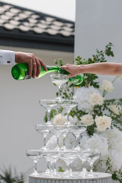 San Diego wedding  couple pouring champagne tower