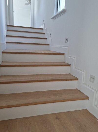 Freshly painted staircase in a new residential build, completed with smooth, detailed finishes by New-Style Painting Service.