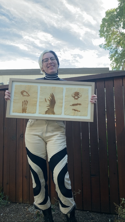 Jules holding a triptych artwork