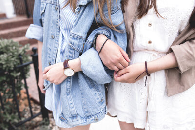 Women walking on a street hand in hand