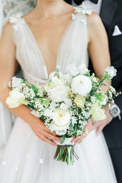 couple holding floral wedding bouquet by sarasota wedding photographer