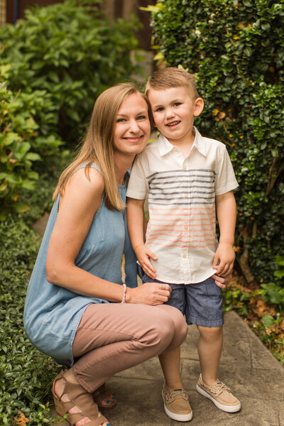 mother crouching next to little boy