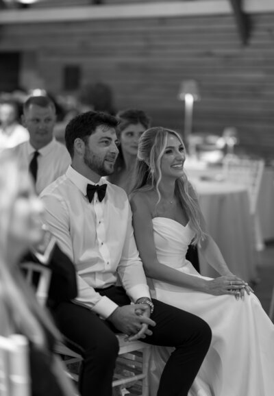 Bride and groom smiling during speeches taken by best wedding photographers in jacksonville fl Shelby Ann Photos