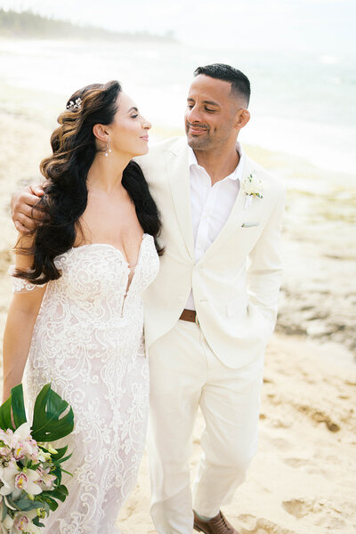 Bride and groom walking hand in hand through Isabela, Puerto Rico