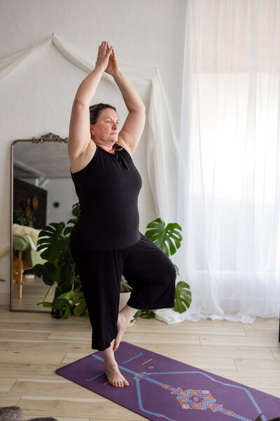 Katie instructs a tree pose for online yoga classes.