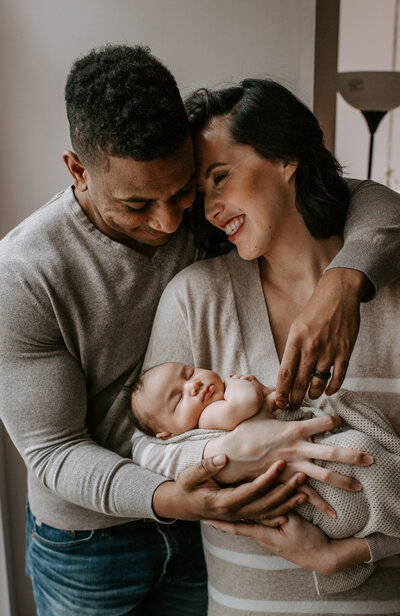 Newborn Photographer, couple holding newborn baby together