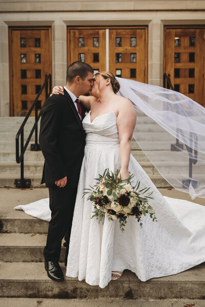 Celebrate love with this stunning Connecticut wedding portrait. Capturing a heartfelt moment between the bride and groom, this classic church wedding features elegant bridal fashion, a flowing veil, and a gorgeous floral bouquet. Book your Connecticut wedding photographer today to create unforgettable memories!