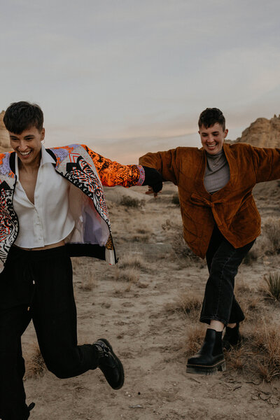 bride and groom standing in front of a lake