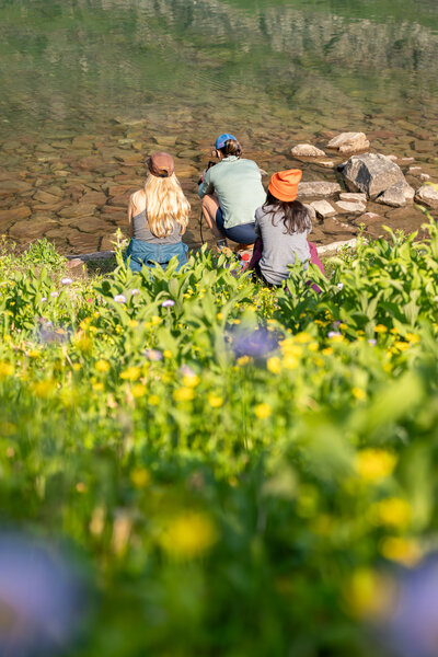 A group of women sit at Old Man Lake in Glacier National Park in Montana