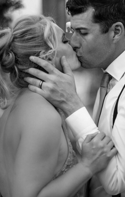 bride and groom kiss on wedding day in North Colorado