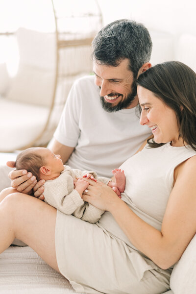 parents hold their newborn during on location photo session