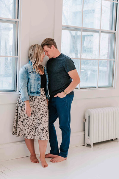 A couple sits on the floor together.