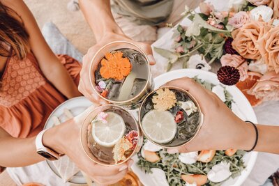 friendly bringing drinks with flowers and citrus as garnishes together for the socialfizz event planning page